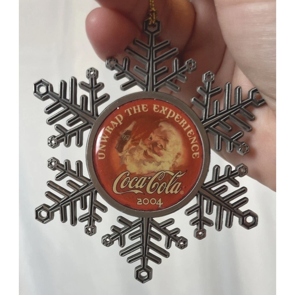 2004 Coca-Cola Metal Snowflake Santa Unwrap the Experience Christmas Ornament